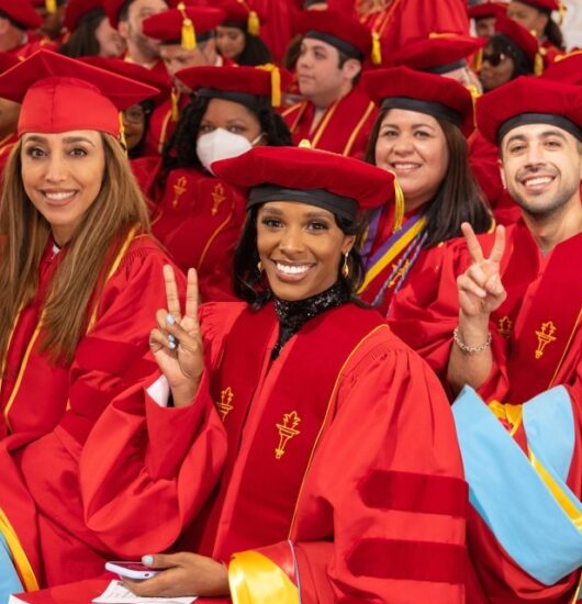 Young students at graduating smiling toward camera