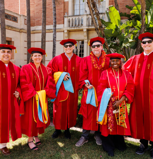 Photo of USC students at graduation posing for a picture.