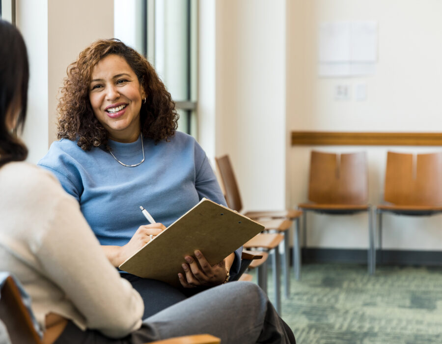 Woman offering counseling while taking notes