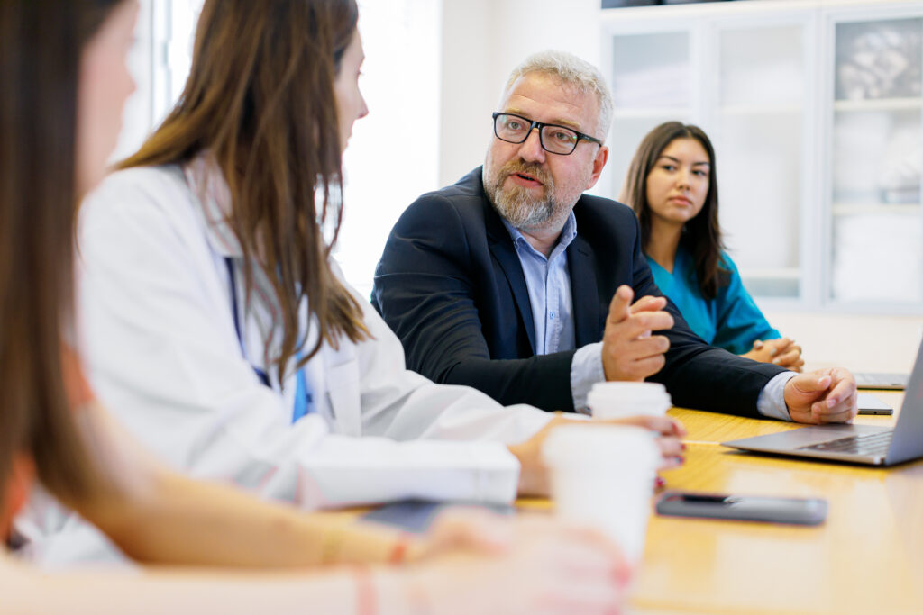 Hospital administrator meeting with physicians and nurses