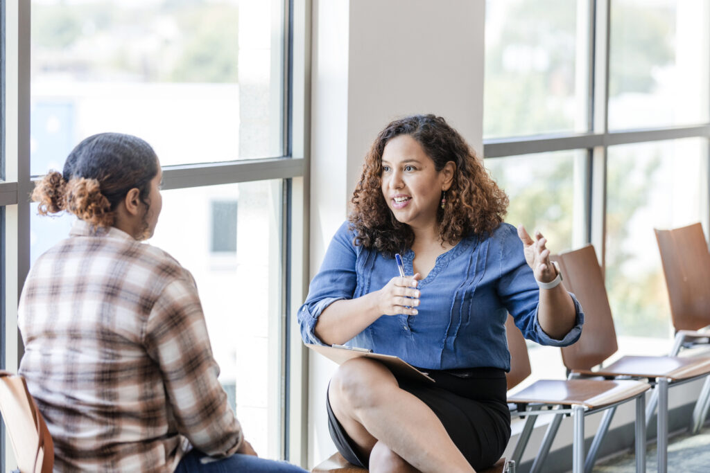 Adult supervisor advising a colleague or student